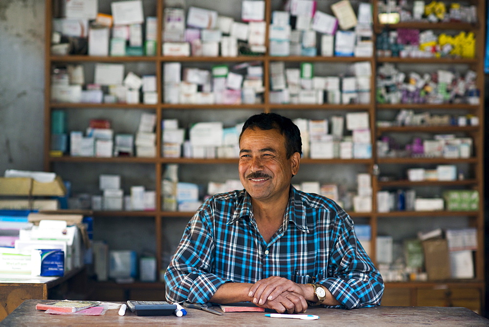 A man working in a dispensary next to a hospital in west Nepal, Asia