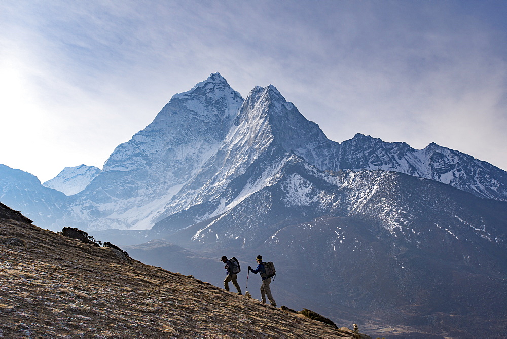 Trekkers climb a small peak above Dingboche in the Everest region in time to see the sunrise, with Ama Dablam in the distance, Himalayas, Nepal, Asia