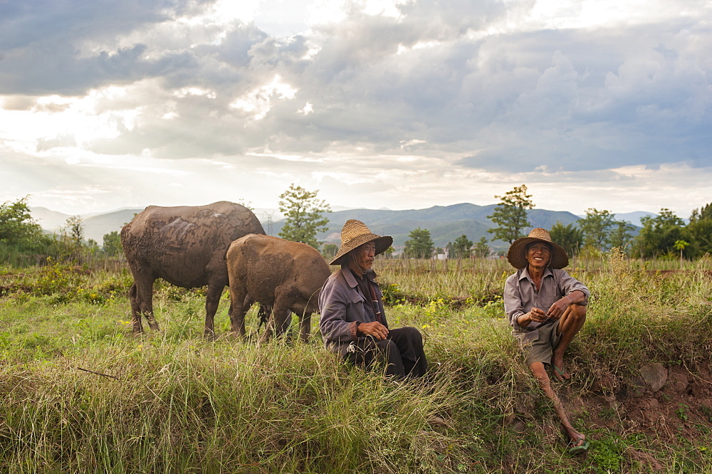 Farmers take a break from working the fields near Yuanmou, Yunnan Province, China, Asia