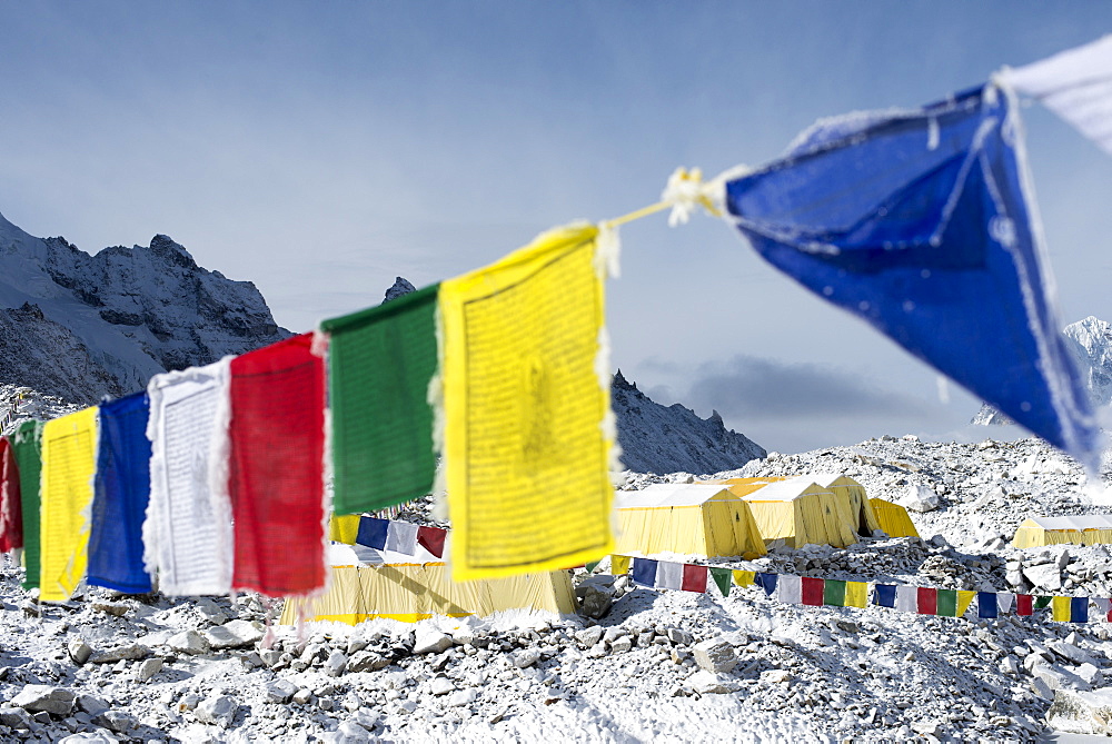 Prayer flags and the Everest base camp at the end of the Khumbu glacier that lies at 5350m, Himalayas, Nepal, Asia