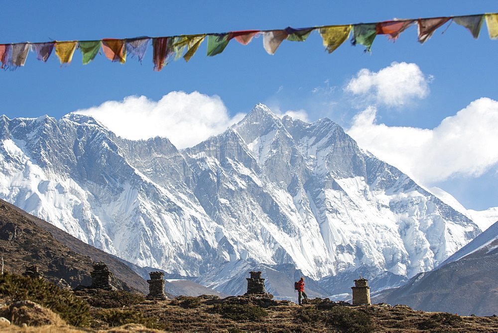 A trekker on their way to Everest Base Camp, Mount Everest is the peak to the left with some spindrift blowing from the top, Himalayas, Nepal, Asia