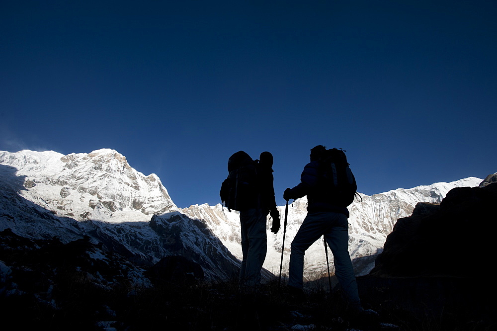 Trekkers on their way down from Annapurna base camp with views of Annapurna 1 in the distance, Himalayas, Nepal, Asia