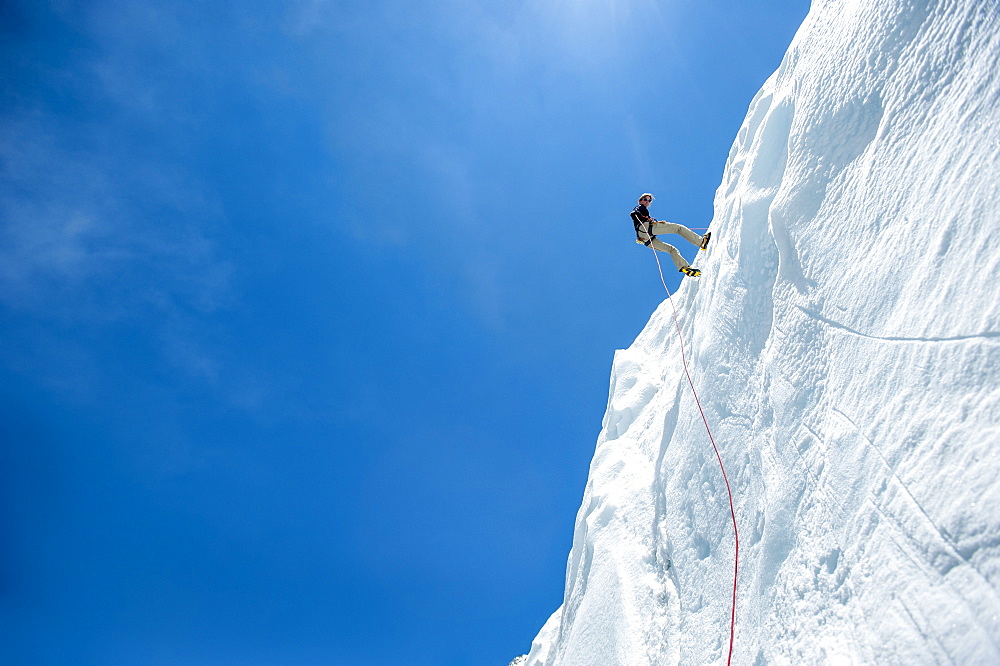 A climber makes her way down an ice wall in preparation for climbing Everest, Himalayas, Nepal, Asia