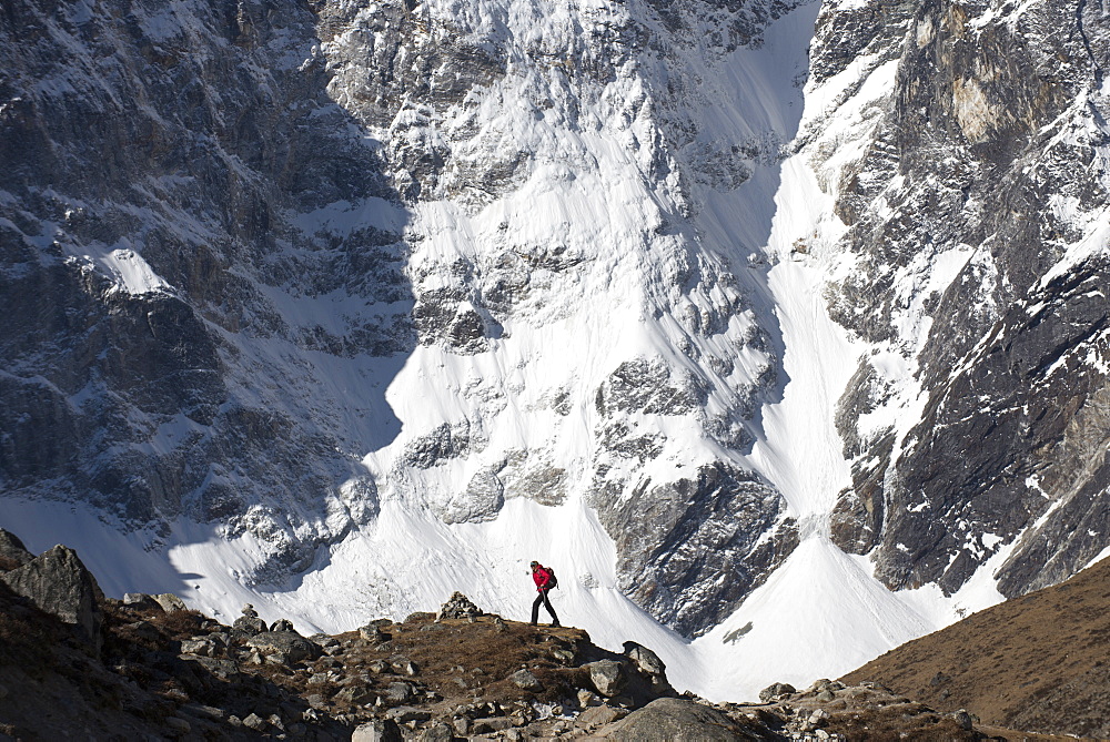 A trekker in the Everest region on the way up to Everest Base Camp walking in front of Cholatse, Khumbu Region, Himalayas, Nepal, Asia