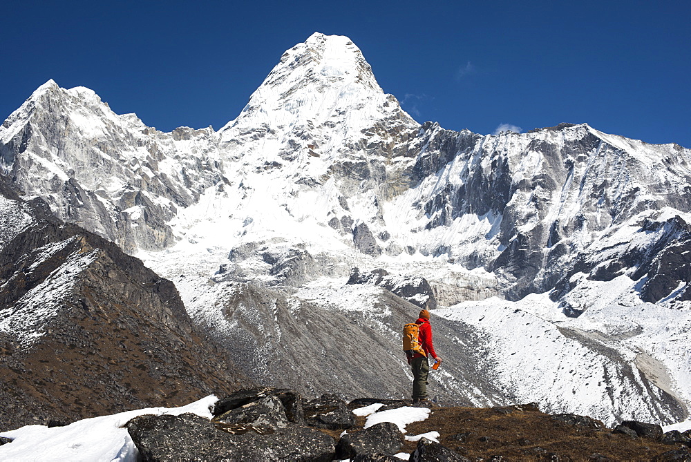 A trekker stops to admire the views of Ama Dablam in the Everest region, Khumbu Region, Himalayas, Nepal, Asia