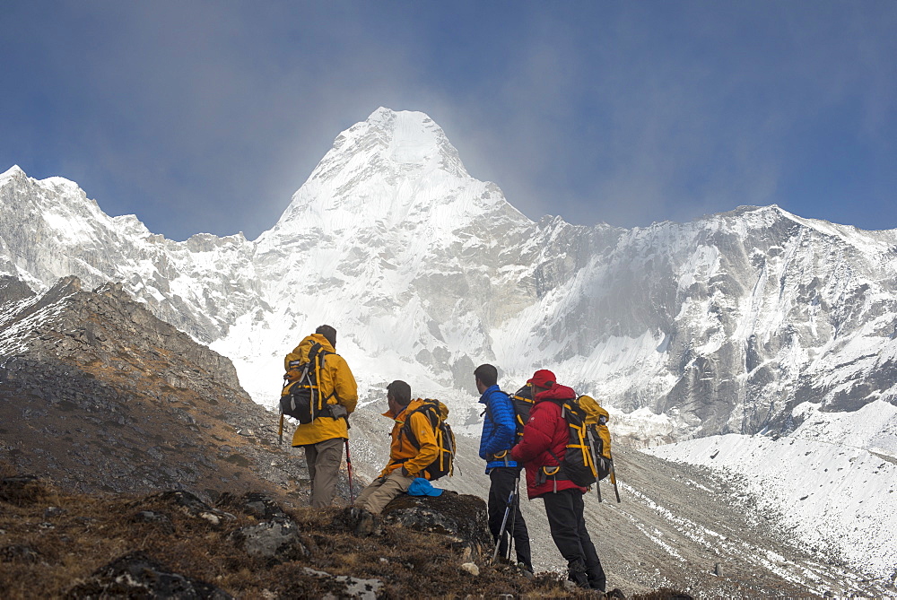 A team of four climbers make their way to Ama Dablam Base Camp, the 6856m peak seen in the distance, Khumbu Region, Himalayas, Nepal, Asia