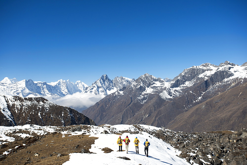 A team of four climbers return to base camp after climbing Ama Dablam in the Nepal Himalayas, Khumbu Region, Nepal, Asia