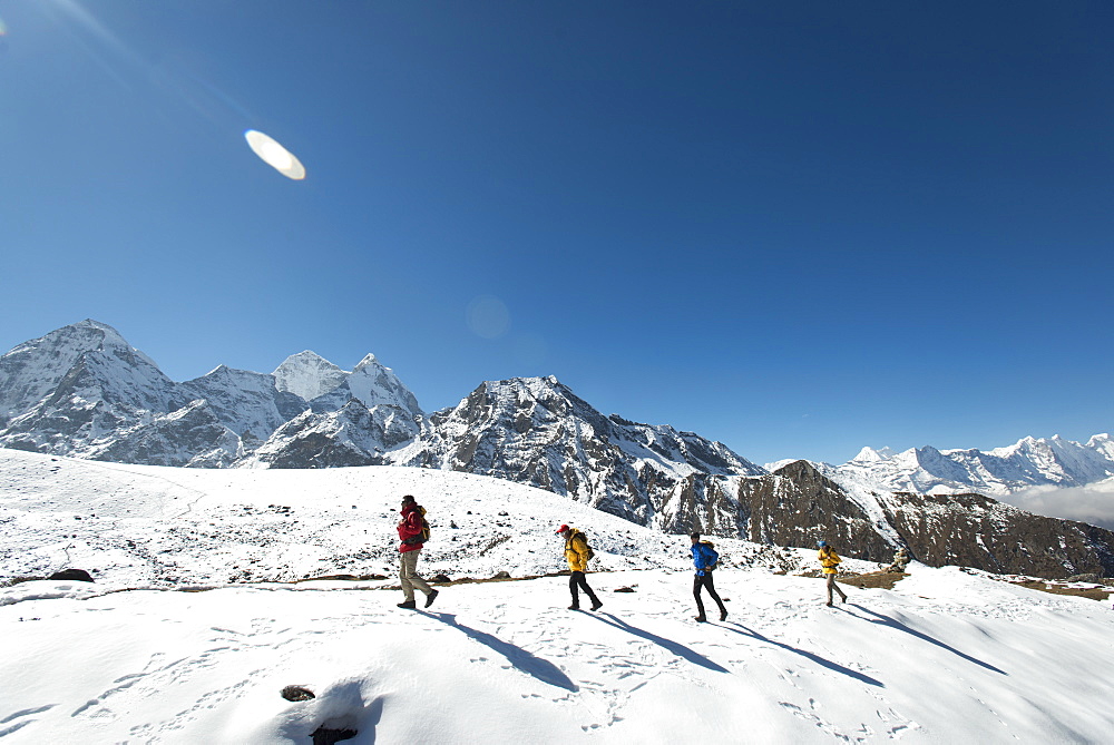 A team of four climbers return to base camp after climbing Ama Dablam in the Nepal Himalayas, Khumbu Region, Nepal, Asia