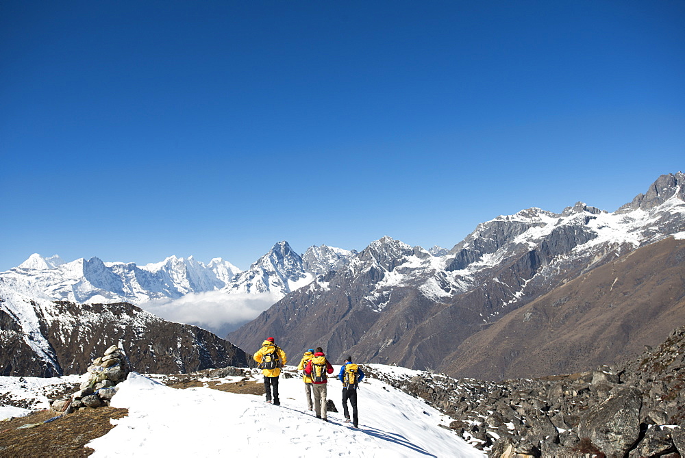 A team of four climbers return to base camp after climbing Ama Dablam in the Nepal Himalayas, Khumbu Region, Nepal, Asia