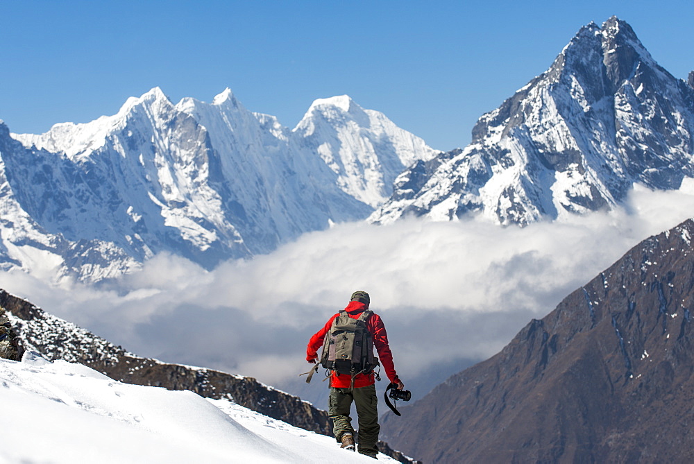 A photographer working in the Everest region of the Nepal Himalayas, Khumbu Region, Nepal, Asia