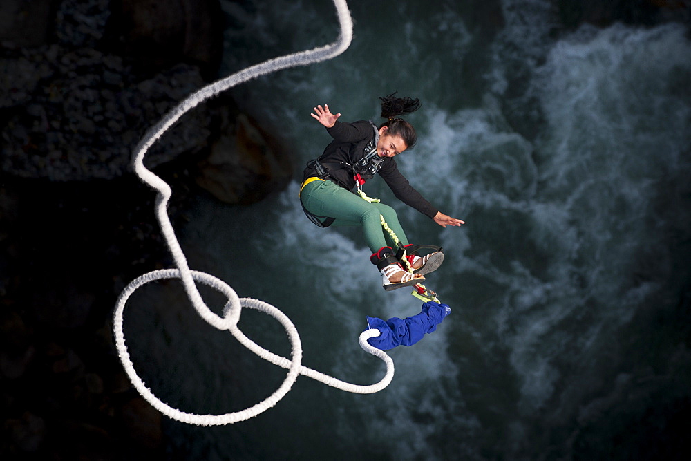 A Nepali girl bungy jumping at The Last Resort in Nepal, Asia