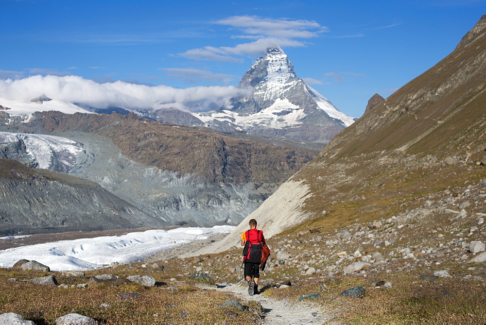 Hiking a trail in the Swiss Alps near Zermatt with a view of The Matterhorn in the distance, Zermatt, Valais, Switzerland, Europe