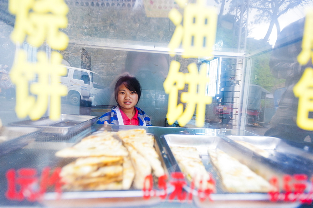 A girl in a shop in Yuanyang, Yunnan Province, China, Asia