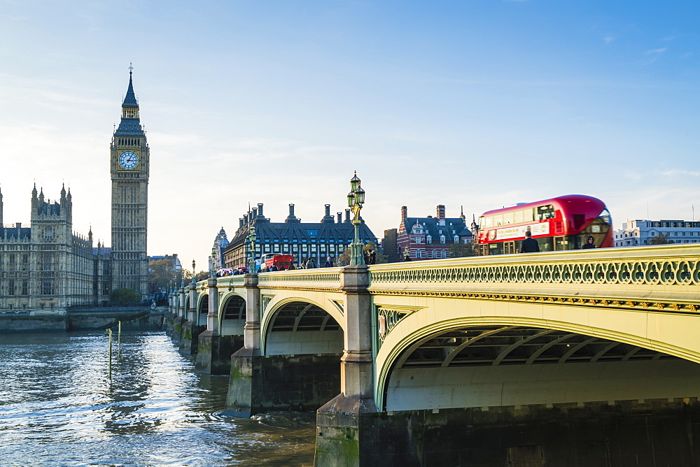 Red bus crossing Westminster Bridge towards Big Ben and the Houses of Parliament, London, England, United Kingdom, Europe