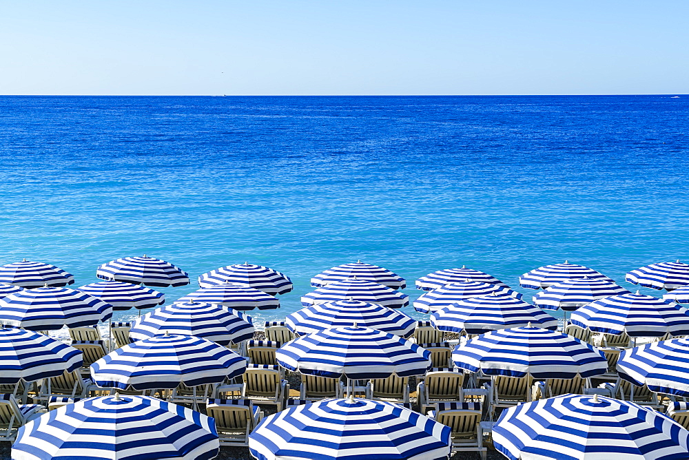 Blue and white beach parasols, Nice, Alpes Maritimes, Cote d'Azur, Provence, France, Mediterranean, Europe