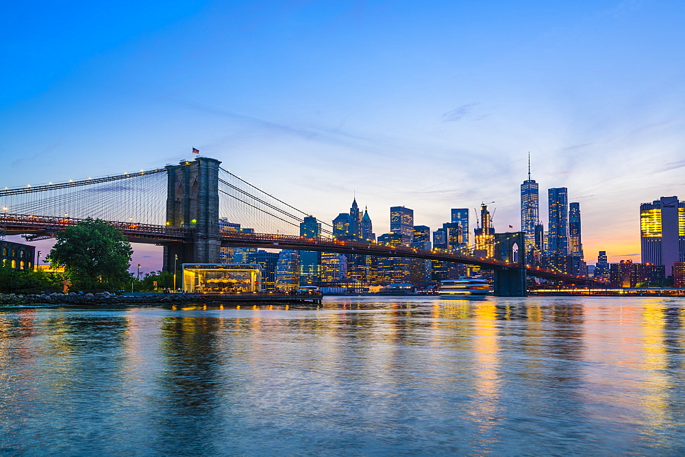 Brooklyn Bridge and Manhattan skyline at dusk, viewed from the East River, New York City, United States of America, North America