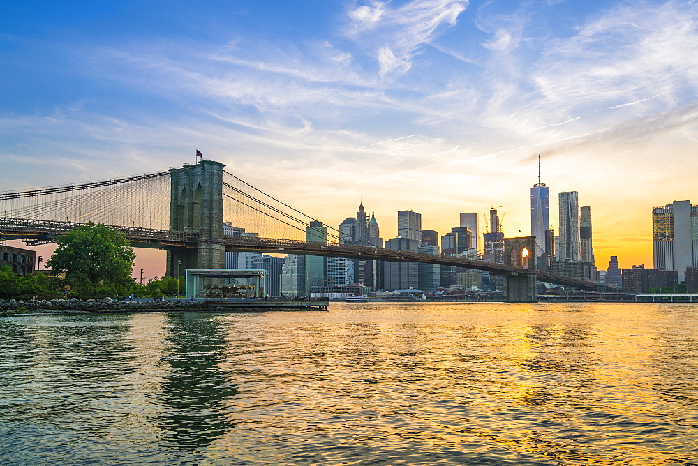 Brooklyn Bridge and Manhattan skyline at dusk, viewed from the East River, New York City, United States of America, North America