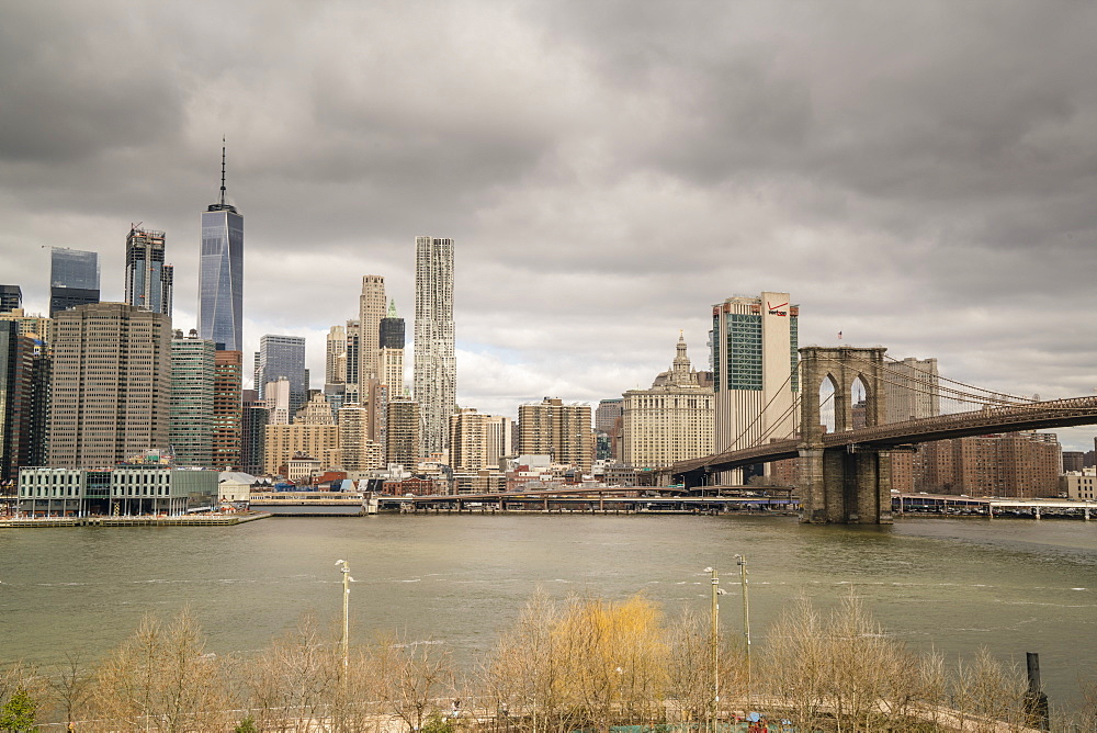 Manhattan skyline and Brooklyn Bridge on a cloudy day, New York City, United States of America, North America