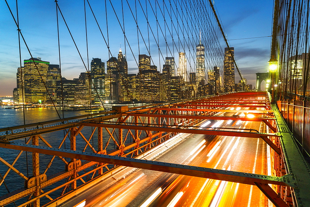 Rush hour traffic at night on Brooklyn Bridge and Manhattan skyline beyond, New York City, United States of America, North America