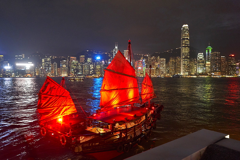 Traditional Chinese junk boat for tourists on Victoria Harbour illuminated at night, Hong Kong, China, Asia