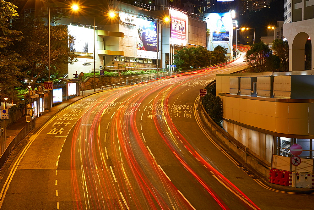 Car light trails on a busy road in Central, Hong Kong Island by night, Hong Kong, China, Asia