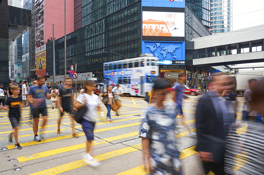 People crossing a busy road in Central, Hong Kong Island's busy shopping and business district, Hong Kong, China, Asia