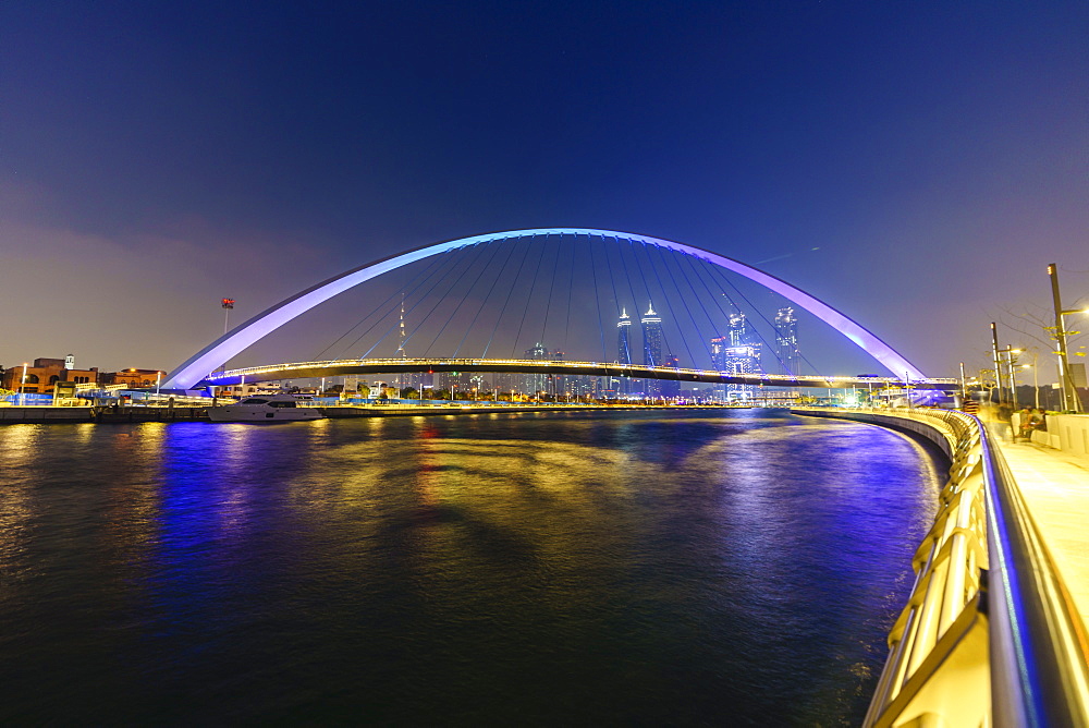 Tolerance Bridge, a pedestrian bridge spanning Dubai Water Canal illuminated at night, Business Bay, Dubai, United Arab Emirates, Middle East