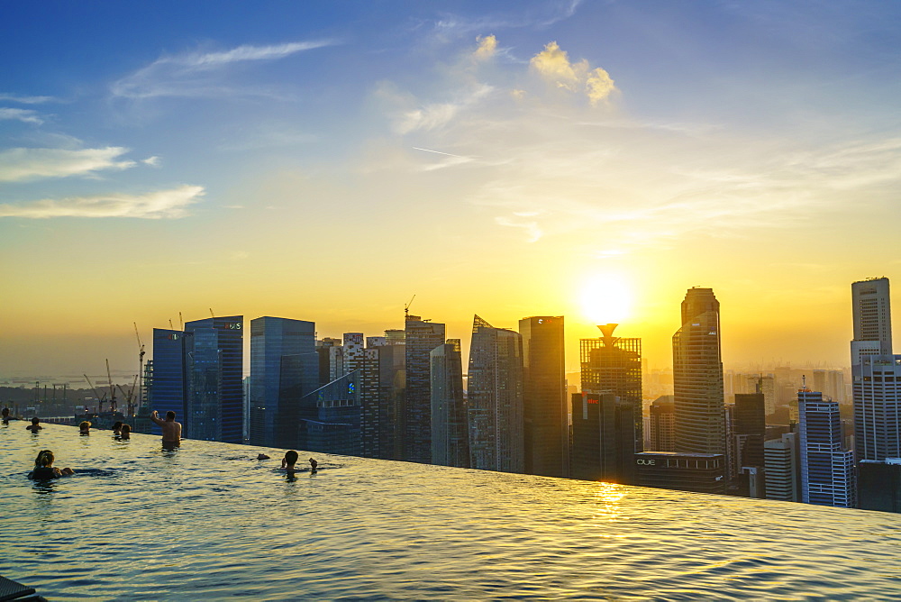 Infinity pool on the roof of the Marina Bay Sands Hotel with spectacular views over the Singapore skyline at sunset, Singapore, Southeast Asia, Asia