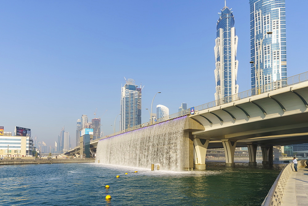 Dubai Water Canal Waterfall Bridge, the waterfall parts to allow boats to pass under, Business Bay, Dubai, United Arab Emirates, Middle East