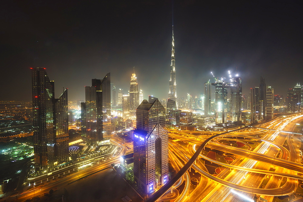 Dubai skyline and Sheikh Zayed Road Interchange by night, Dubai, United Arab Emirates, Middle East