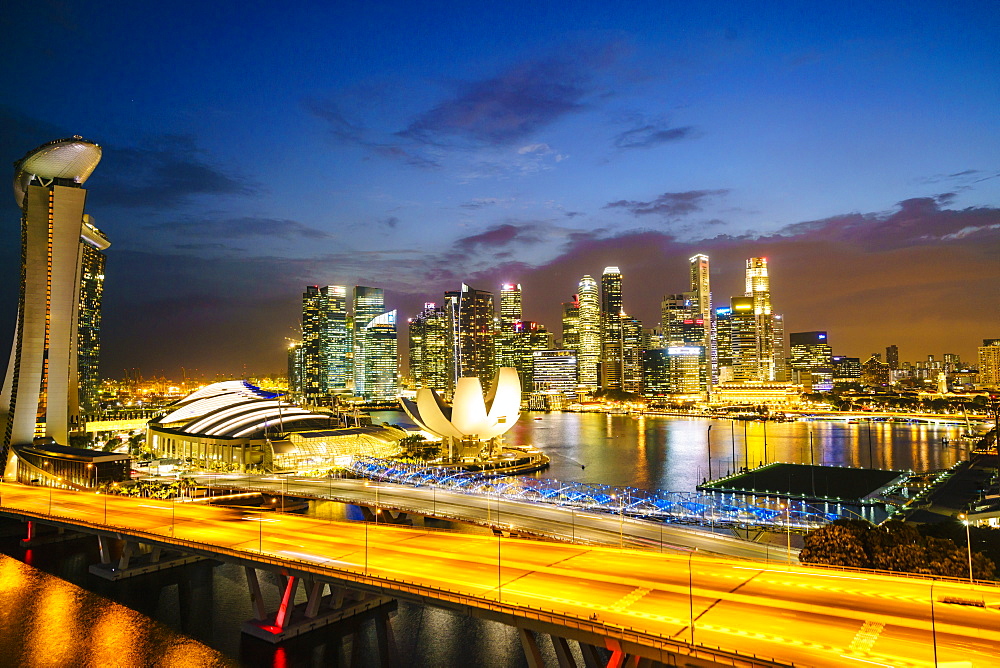 Busy roads leading to the Marina Bay Sands, Gardens by the Bay and ArtScience Museum at dusk with the skyline beyond, Singapore, Southeast Asia, Asia