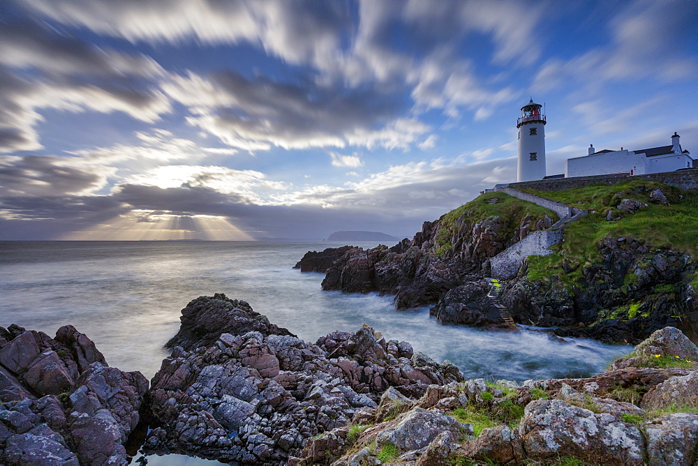 Sunrise over the Atlantic Ocean and Fanad Head Lighthouse in County Donegal, Ulster, Republic of Ireland, Europe