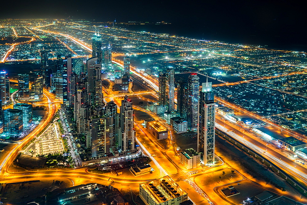 The street lights and skyscrapers of Dubai are seen at night from high above the city, Dubai, United Arab Emirates, Middle East