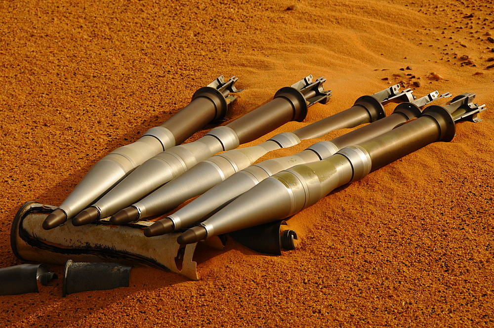 Disarmed RPG grenades abandoned on sand, Ennedi, Sahara Desert, Chad