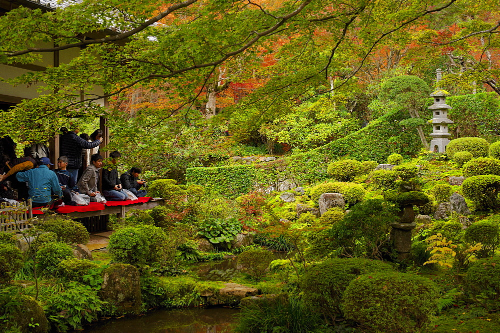 Tourists enjoying early autumn colours in Sanzen-in Temple, Kyoto, Japan, Asia