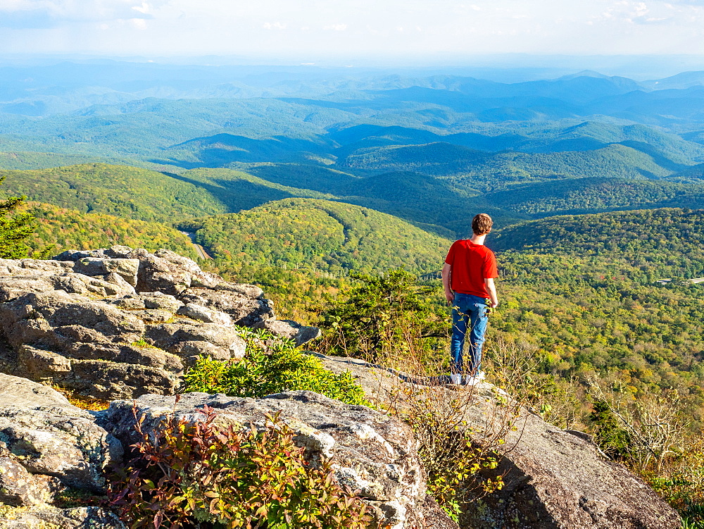 Boy looks at the view from the peak of Grandfather Mountain, Blue Ridge Mountains, Appalachia, North Carolina, United States of America, North America