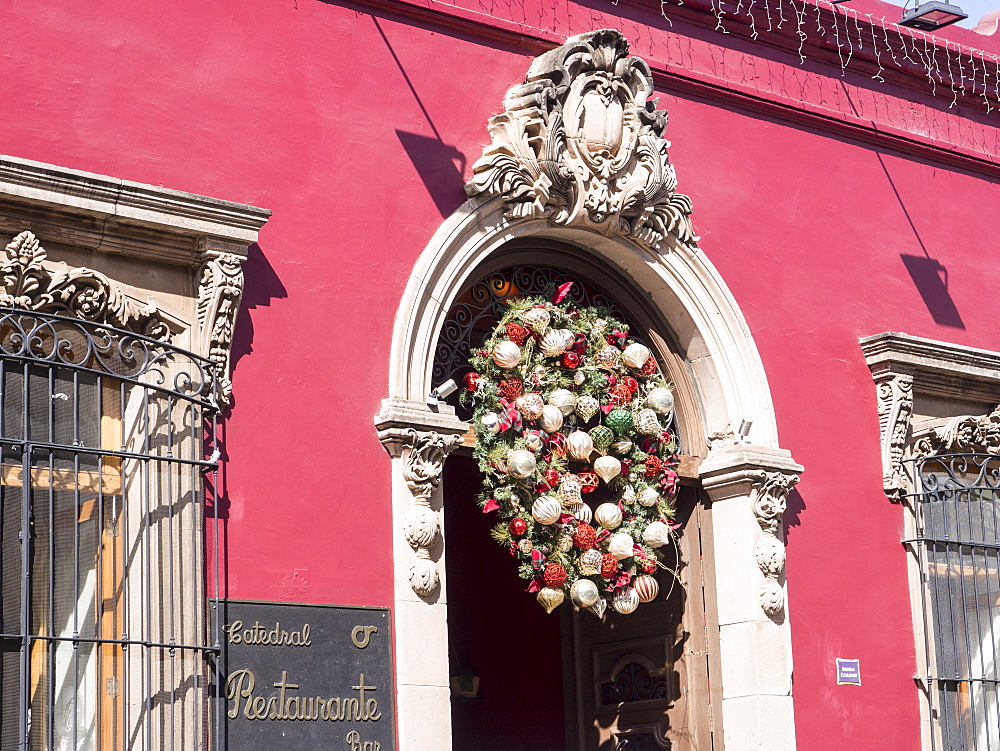 Red building with Christmas decorations, Catedral Restaurante, Oaxaca, Mexico, North America