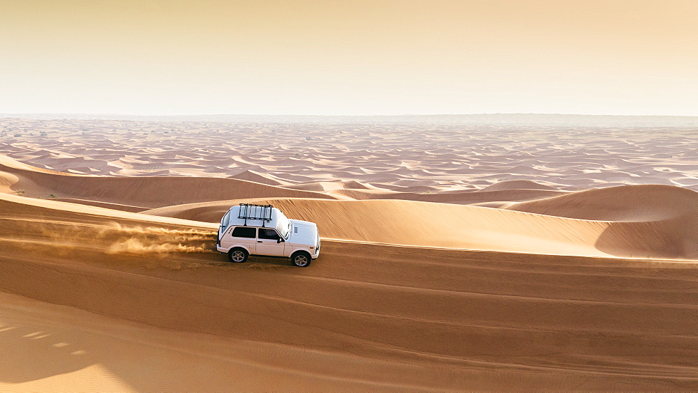 Offroad vehicle on sand dunes near Dubai, United Arab Emirates, Middle East