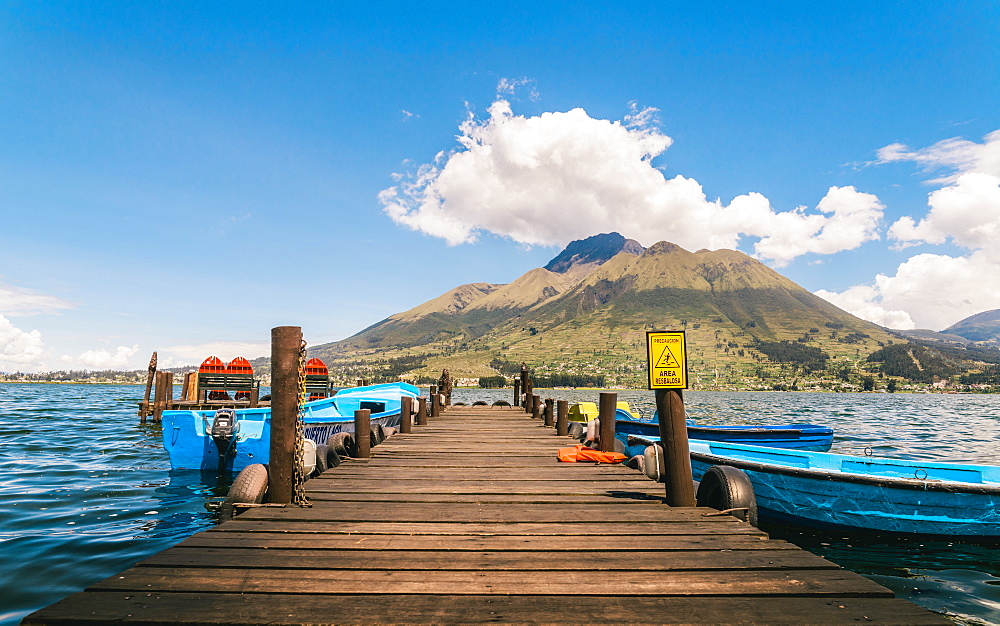 A pier and boat on Lago San Pablo, at the base of Volcan Imbabura, close to the famous market town of Otovalo, Ecuador, South America