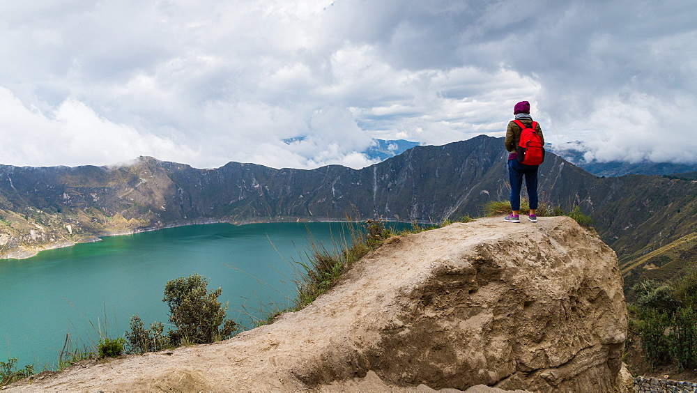 A woman started at Quilotoa, a water-filled caldera and the most western volcano in the Ecuadorian Andes, Ecuador, South America