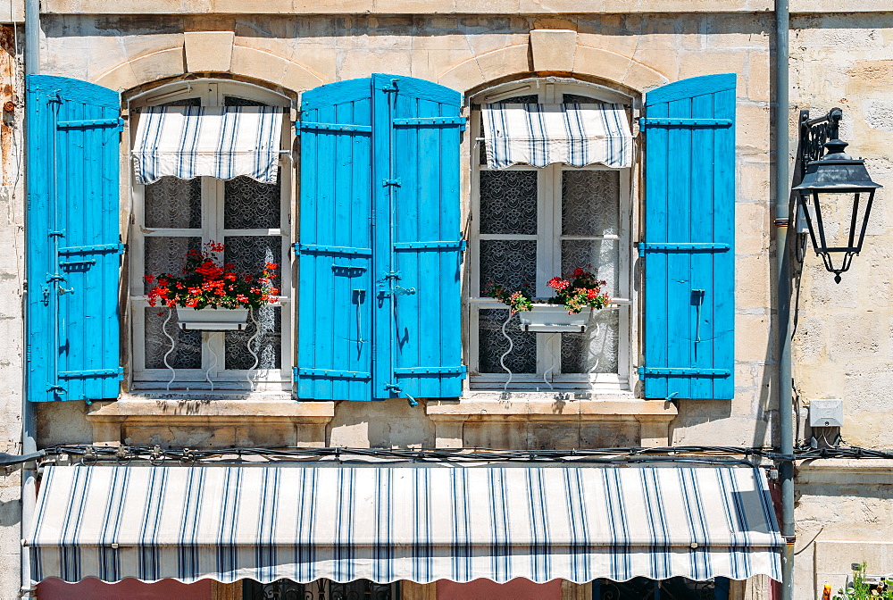 Traditional Provencal building facade in the historic centre of Arles, a city on the Rhone River in Provence, France, Europe