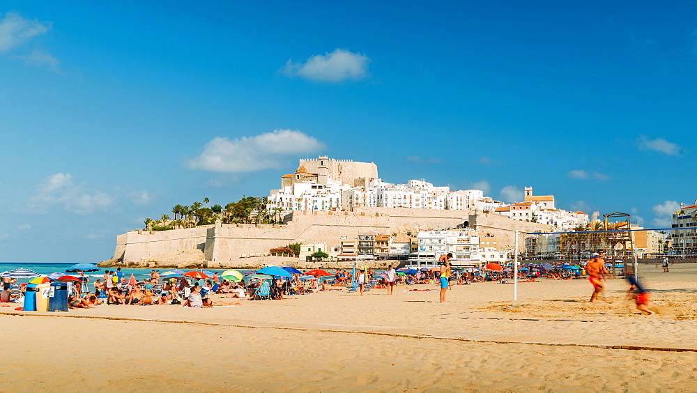 Crowded beach and the medieval fort town of Peniscola, Castellon, Spain, Europe