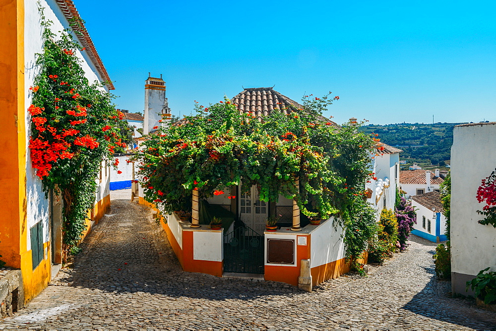 Narrow quaint streets within the ancient fortified village of Obidos, Oeste, Leiria District, Portugal, Europe