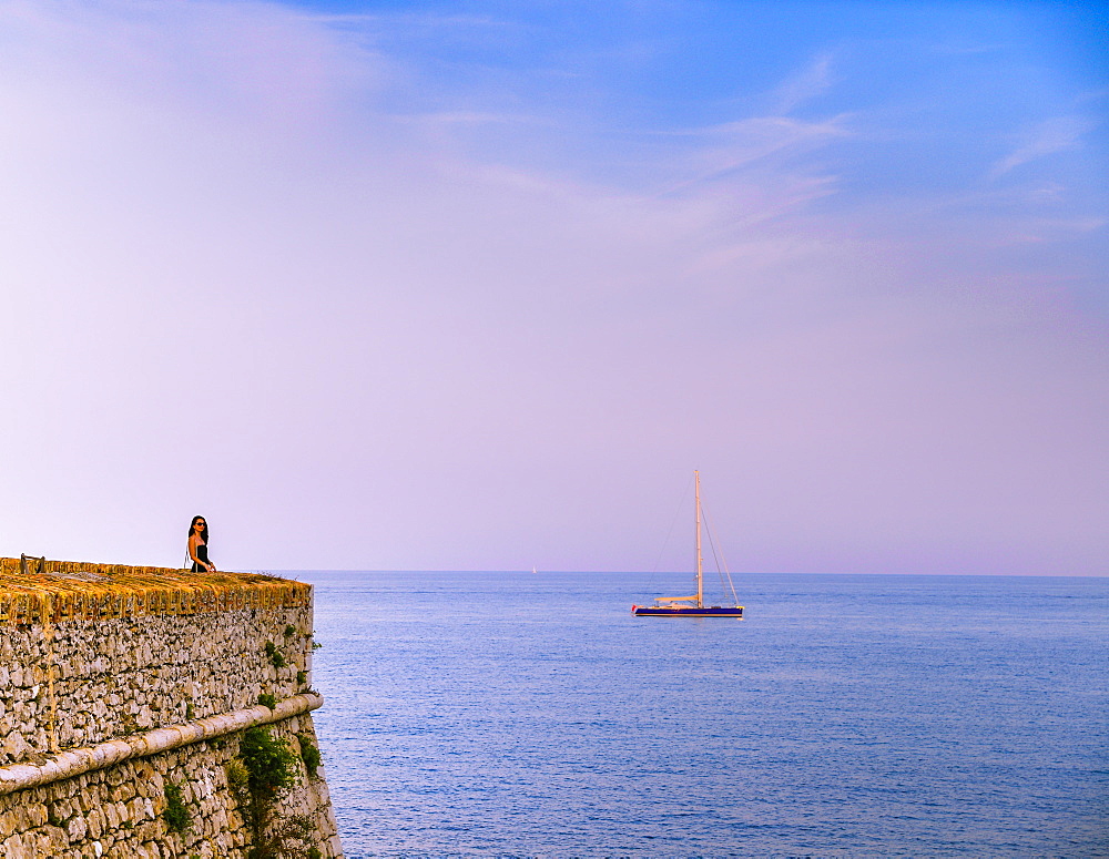 Woman alone at sunset next to the sea, Antibes, Cote d'Azur, French Riviera, France, Mediterranean, Europe