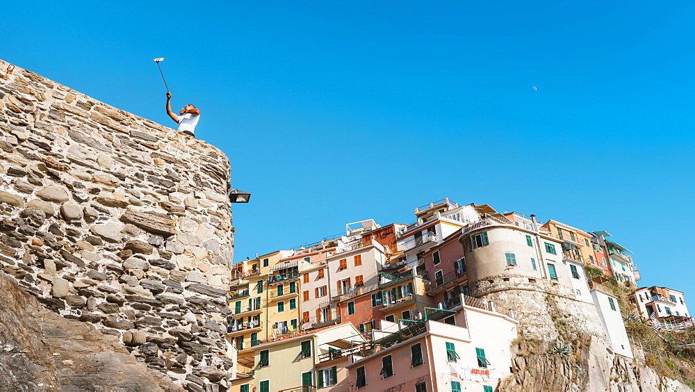 A man taking a selfie at Manarola, Cinque Terre, UNESCO World Heritage Site, Liguria, Italian Riviera, Italy, Europe