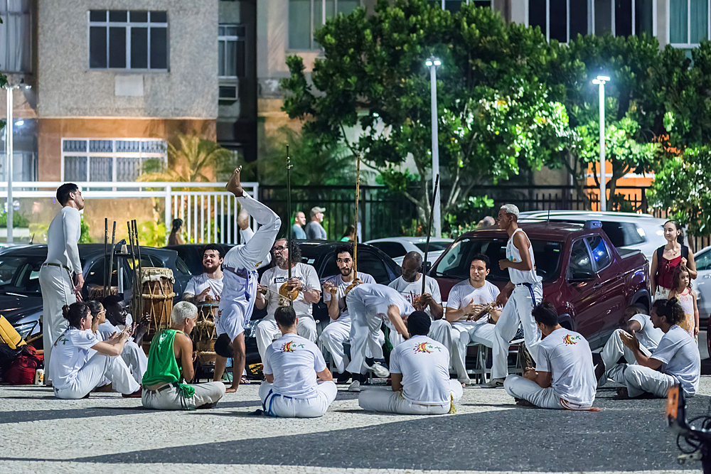 People practise Capoeira, a fast and versatile martial art historically focused on fighting when outnumbered or at a technological disadvantage between slaves and their masters in colonial times, Copacabana, Rio de Janeiro, Brazil, South America