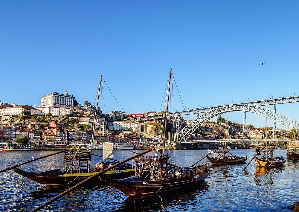 Traditional boats on Vila Nova de Gaia bank of Douro River, Dom Luis I Bridge in the background, UNESCO World Heritage Site, Porto, Portugal, Europe