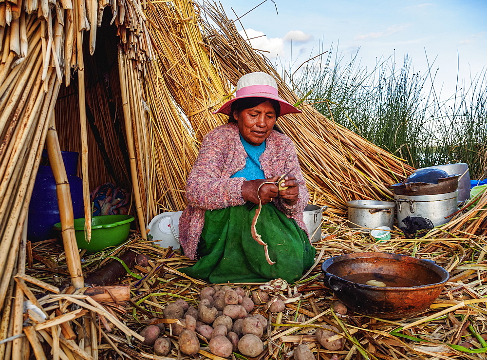 Native Uro Lady cooking, Uros Floating Islands, Lake Titicaca, Puno Region, Peru, South America