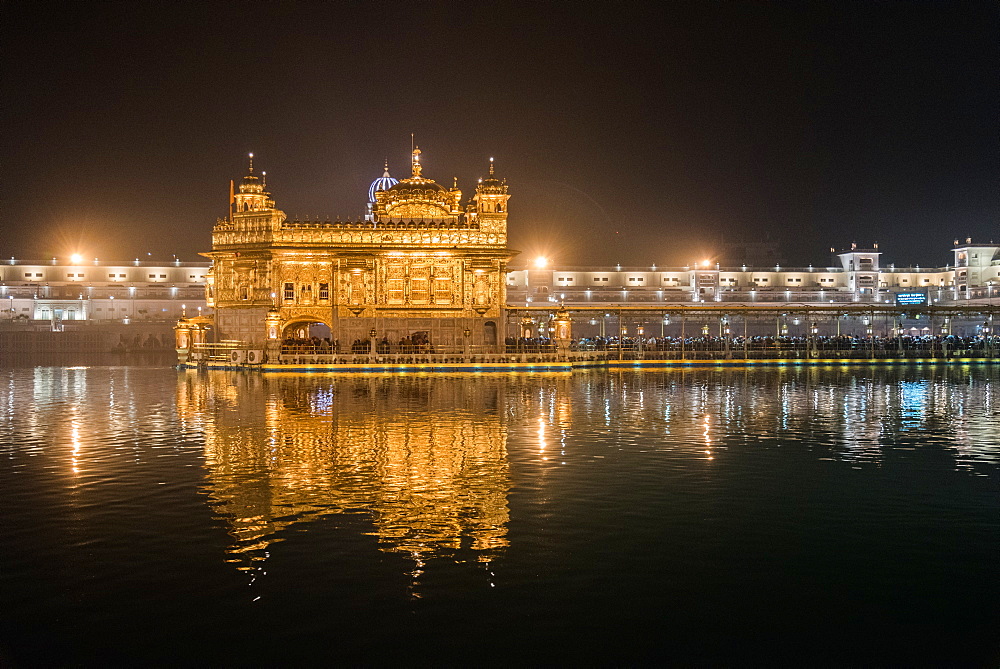 Night time reflections, The Golden Temple, Amritsar, Punjab, India, Asia