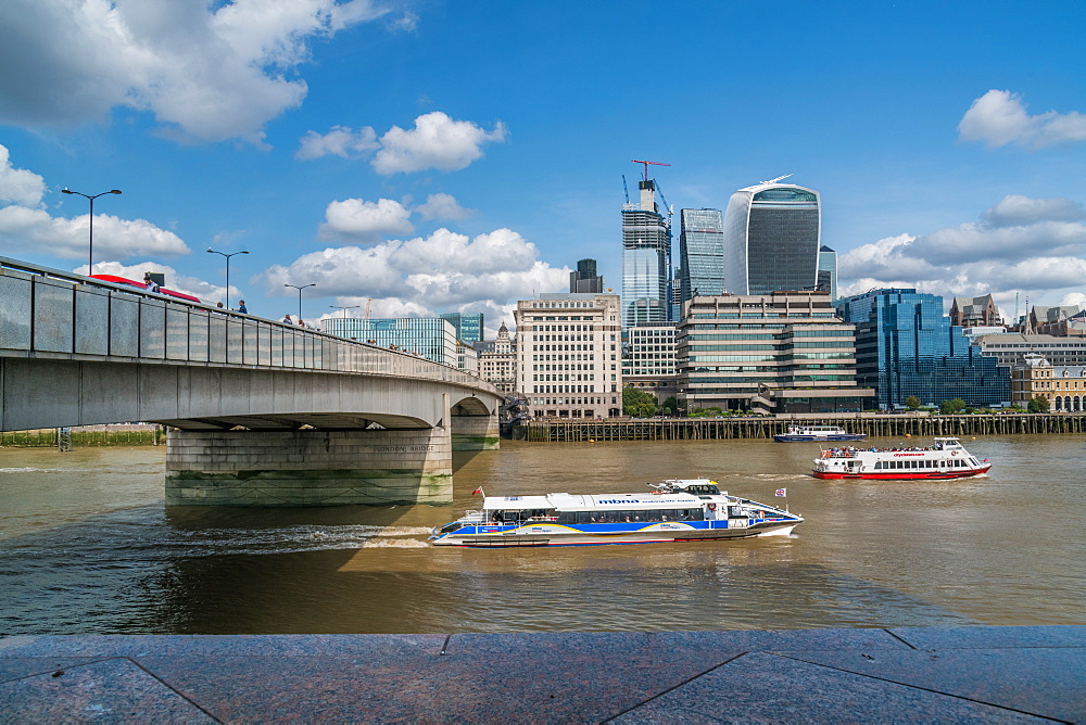 Two public boats race down the River Thames, London England, United Kingdom, Europe